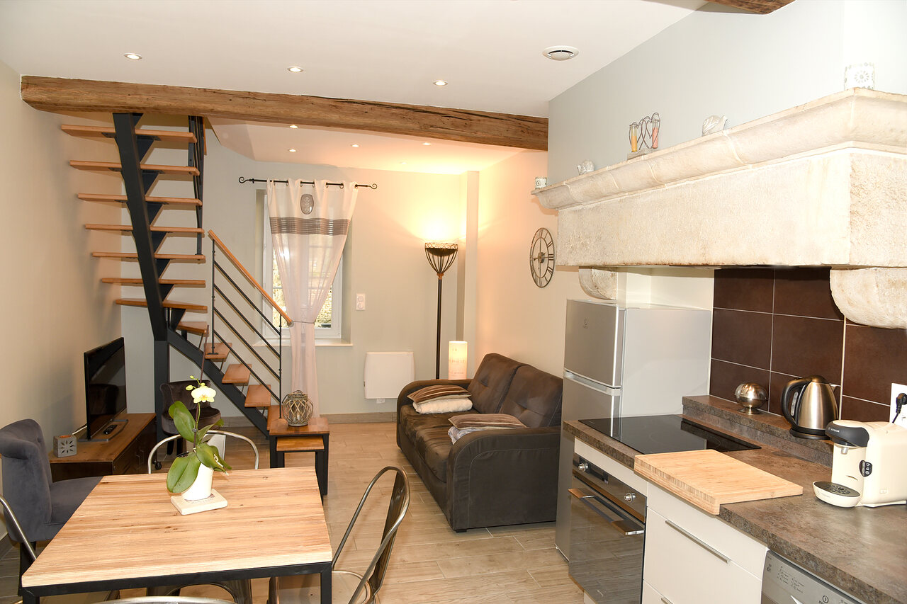 The living room, the wooden table and the staircase